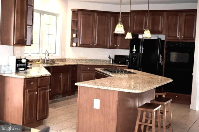 a kitchen with a sink a stove and cabinets