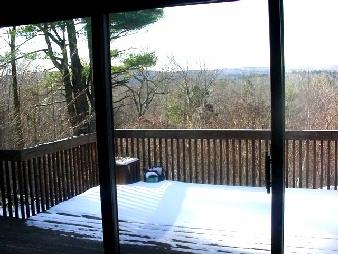 185 Capt Whitney Road Becket, MA 01223 - Photo 2 of 2 a view of a balcony with floor to ceiling window wooden fence