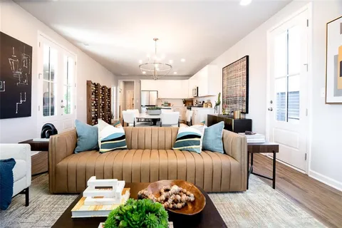 a living room with furniture and a chandelier