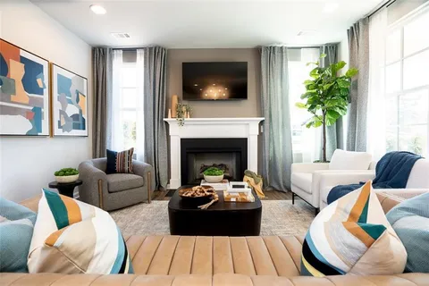 a living room with furniture fireplace and window