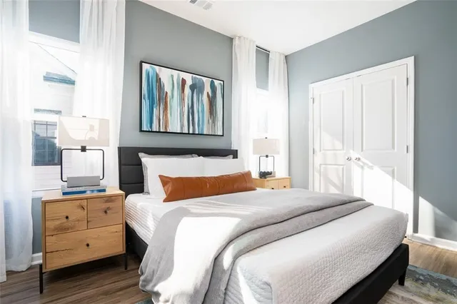 a bedroom with a bed and wooden floor