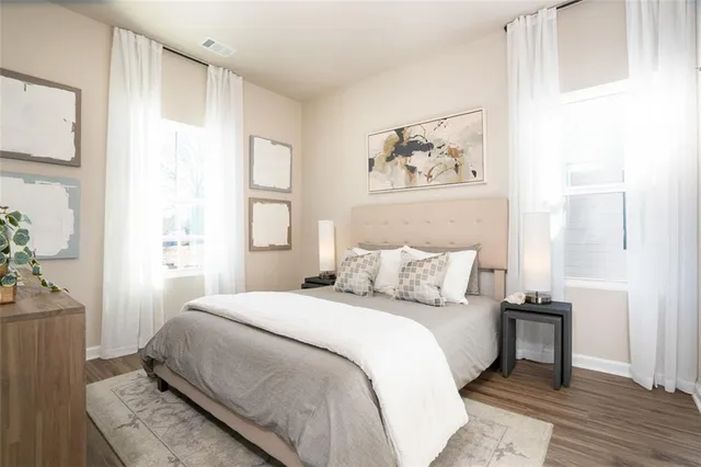 a bedroom with a large bed and a window