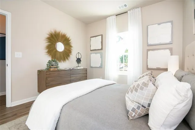 a bedroom with a bed and a window