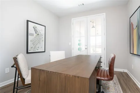 a view of a dining room with furniture and window