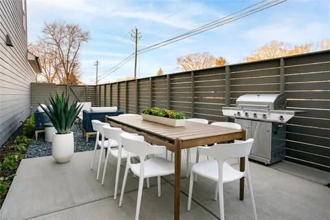 a balcony with table and chairs