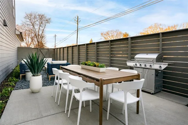 a balcony with table and chairs