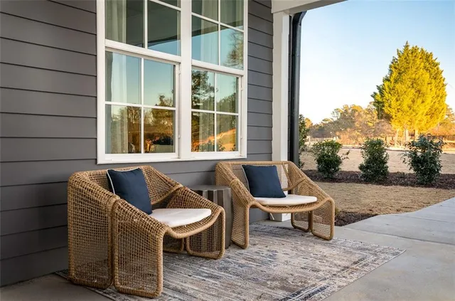 a balcony with table and chairs