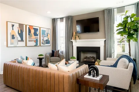 a living room with furniture fireplace and flat screen tv