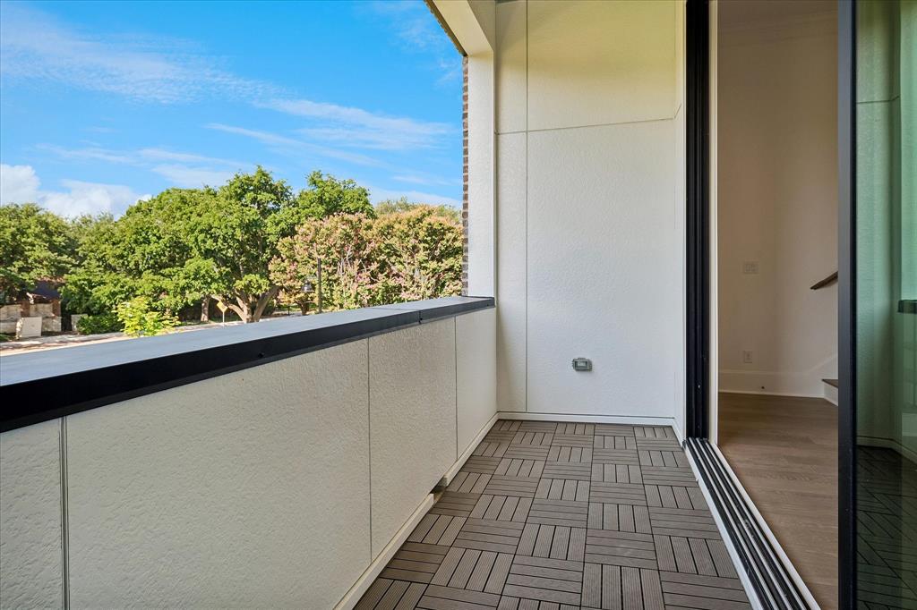 6019 Laurel Lane Addison, TX 75001 - Photo 5 of 21 Outdoor balcony featuring modular wood-finish flooring and a black railing