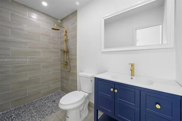 a view of a white house with a big yard plants and large trees