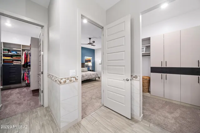 a view of a hallway and a livingroom with furniture