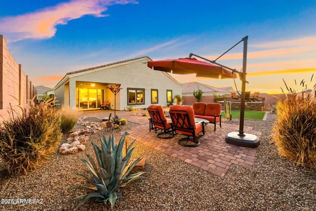 a view of a porch with furniture and floor to ceiling window