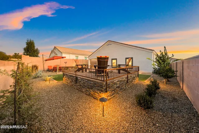 a view of a house with backyard porch and sitting area