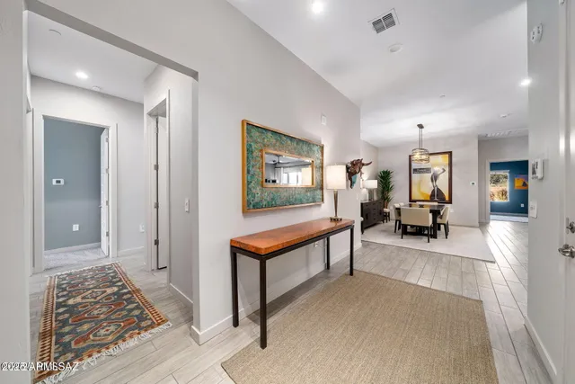 a living room with furniture a rug and a painting on the wall