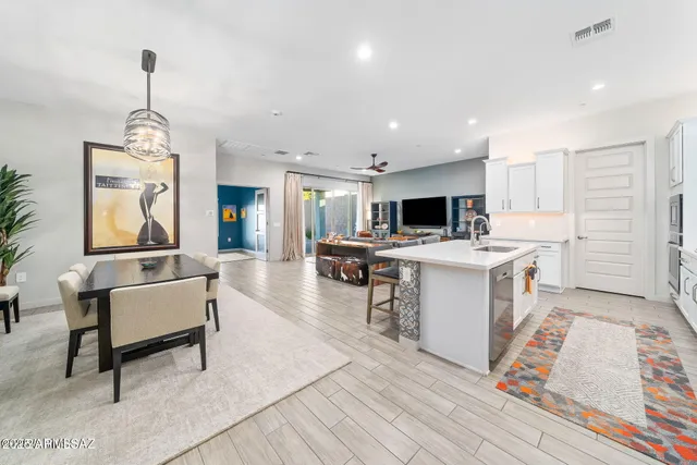 a living room with furniture and kitchen view