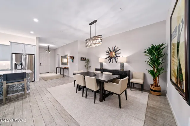 a dining room with furniture potted plants and wooden floor