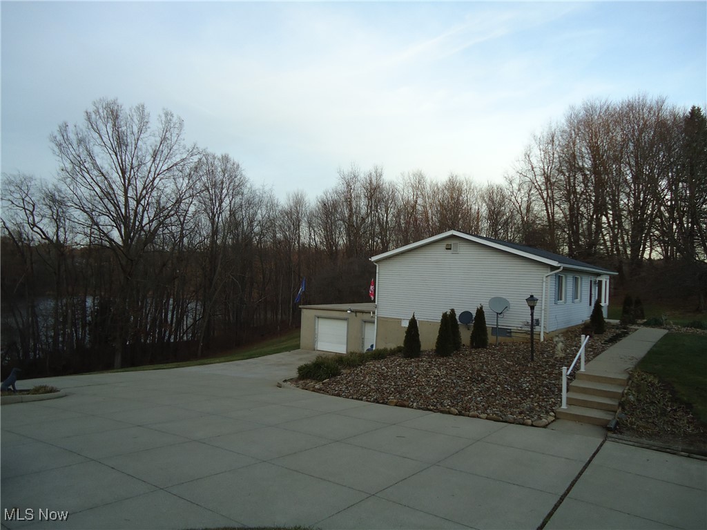 539 East Nimisila Road Uniontown, OH 44685 - Photo 20 of 41 View of property exterior featuring a garage