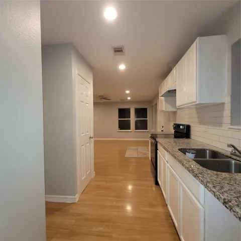 a kitchen with a sink and refrigerator
