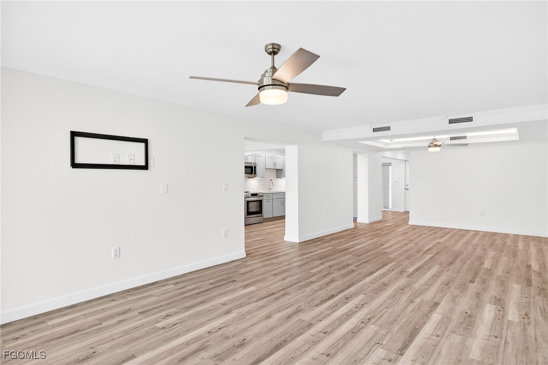 200 Periwinkle Way, Unit 124 Sanibel, FL 33957 - Photo 12 of 50 a view of empty room with wooden floor
