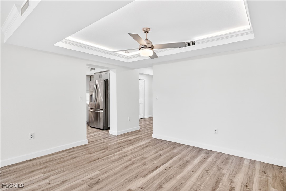 200 Periwinkle Way, Unit 124 Sanibel, FL 33957 - Photo 16 of 50 a view of an empty room with wooden floor