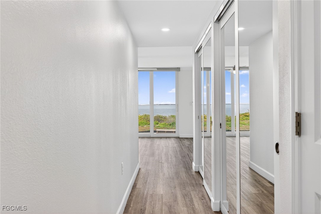 200 Periwinkle Way, Unit 124 Sanibel, FL 33957 - Photo 23 of 50 a view of a hallway with wooden floor and closet