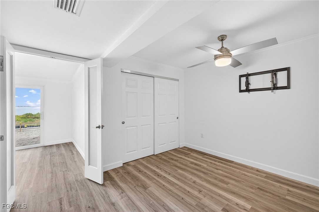 200 Periwinkle Way, Unit 124 Sanibel, FL 33957 - Photo 31 of 50 a view of empty room with wooden floor