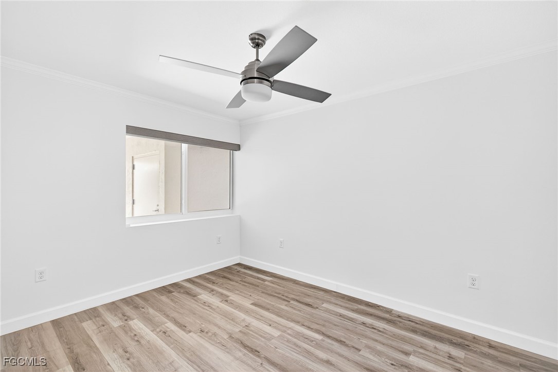 200 Periwinkle Way, Unit 124 Sanibel, FL 33957 - Photo 34 of 50 an empty room with a window and ceiling fan
