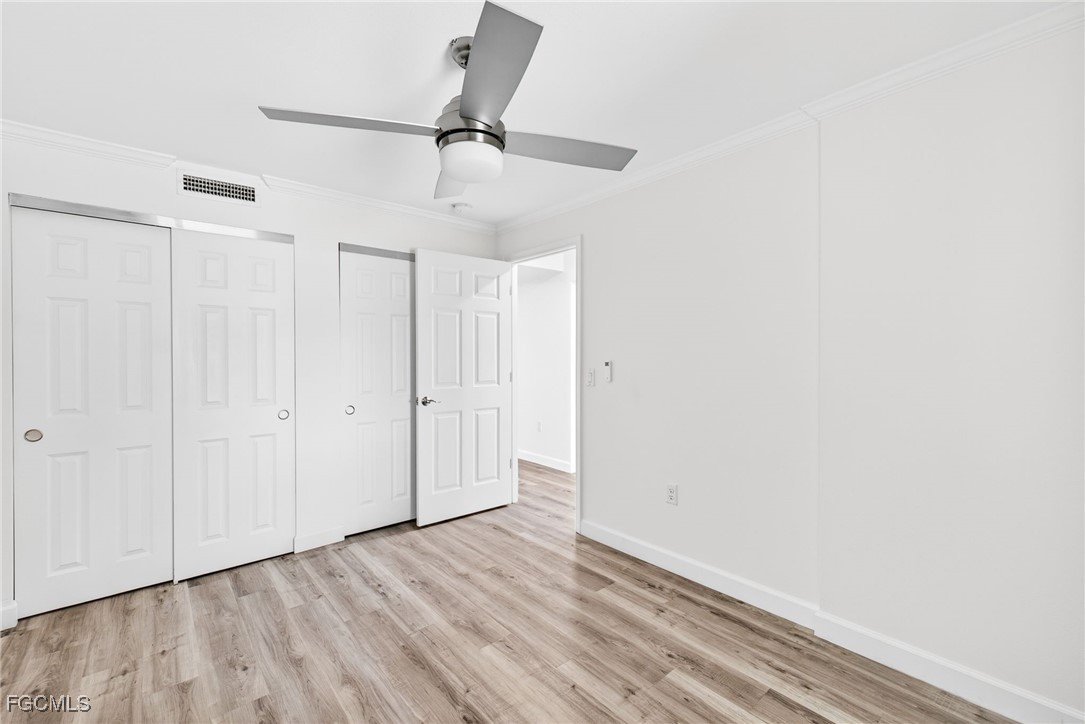 200 Periwinkle Way, Unit 124 Sanibel, FL 33957 - Photo 35 of 50 a view of empty room with wooden floor