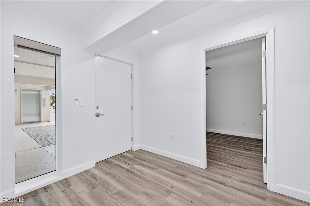 200 Periwinkle Way, Unit 124 Sanibel, FL 33957 - Photo 37 of 50 wooden floor in an empty room with wooden floor