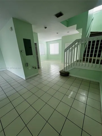 a kitchen with a sink a refrigerator and cabinets