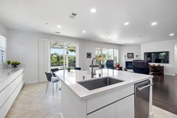 a kitchen with a sink stainless steel appliances and cabinets