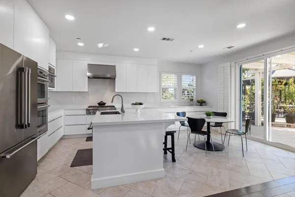 a kitchen with cabinets and stainless steel appliances