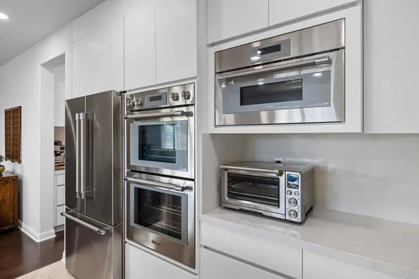 a kitchen with a stove and white cabinets