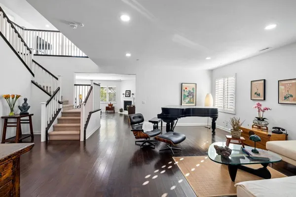 a living room with furniture and wooden floor