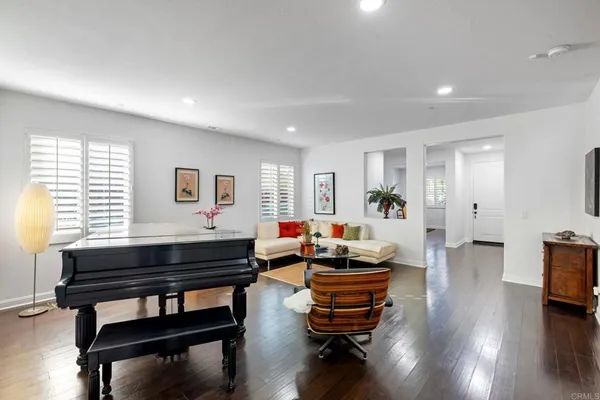 a view of a room with wooden floor table and chairs