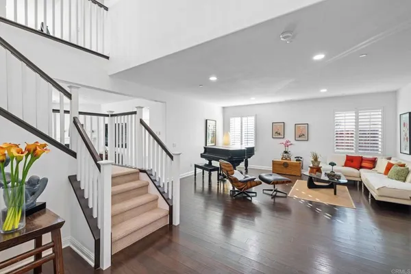 a living room with furniture and wooden floor