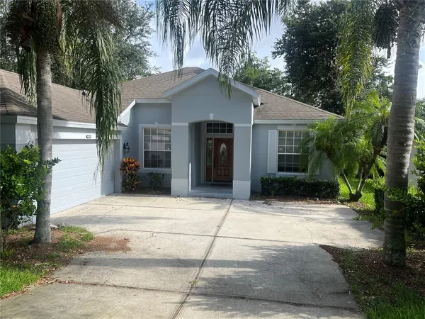 a front view of a house with a yard and a garage