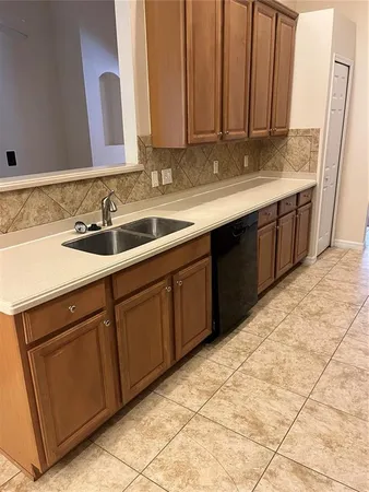a kitchen with a sink and cabinets
