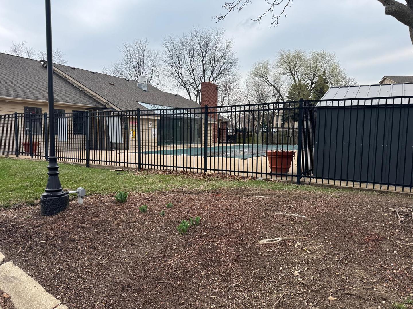 1935 North Hicks Road, Unit 106 Palatine, IL 60074 - Photo 3 of 16 a view of a house with backyard and wooden fence