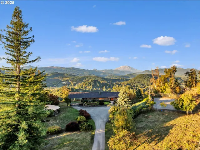 a view of a city with lots of residential buildings ocean and mountain view in back