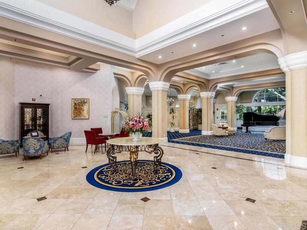 a lobby with furniture and a chandelier
