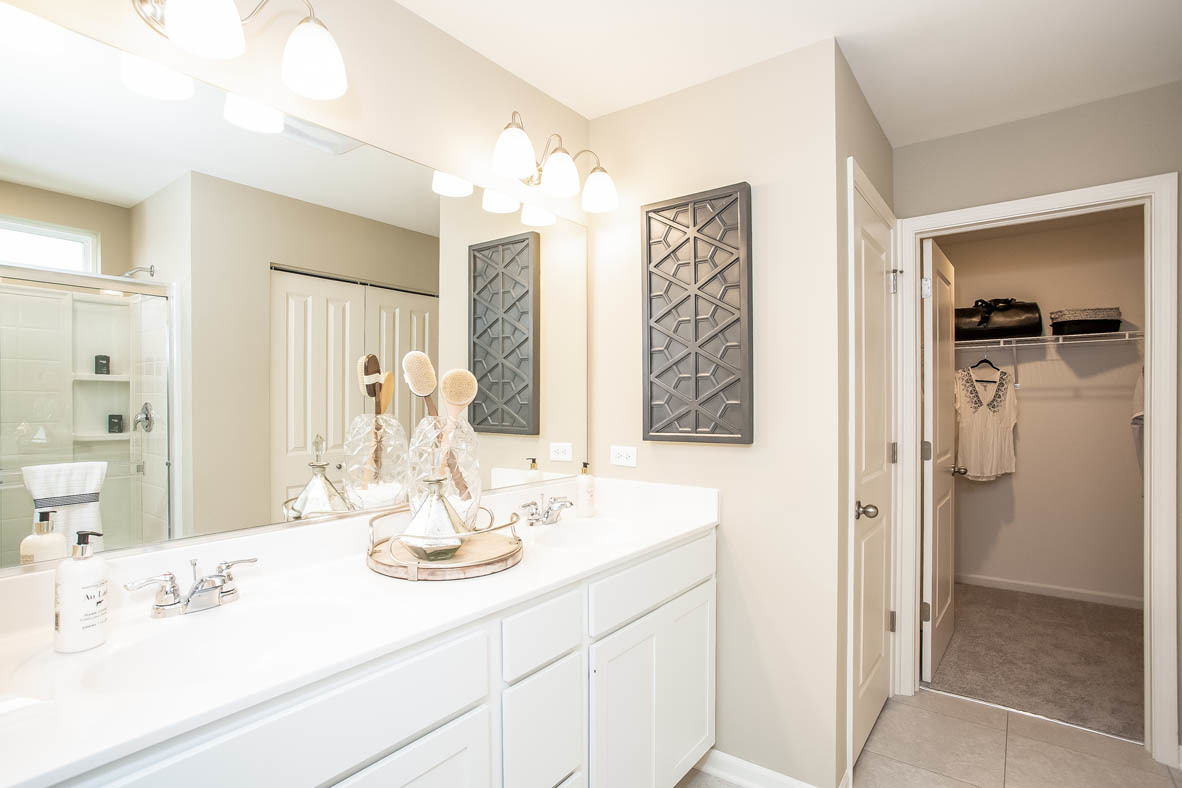 3818 Doherty Lane McHenry, IL 60050 - Photo 10 of 10 a bathroom with a double vanity sink mirror and shower