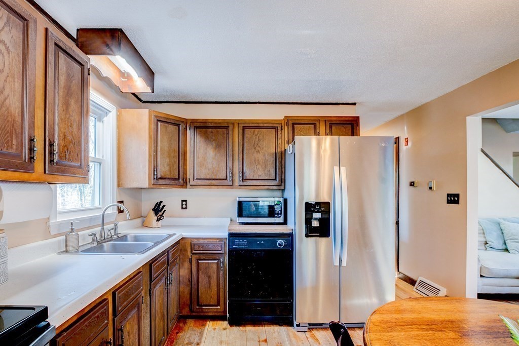 103 Dunn Road Ashburnham, MA 01430 - Photo 5 of 30 a kitchen with stainless steel appliances a refrigerator and a sink