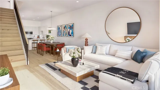 a living room with furniture a rug and a mirror