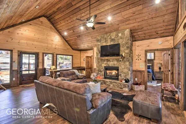 a living room with fireplace furniture and a flat screen tv