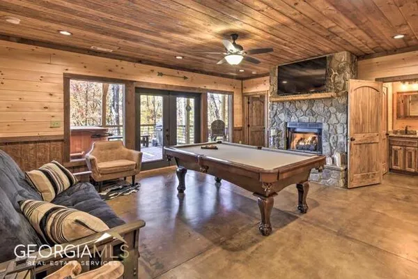 a living room with furniture a fireplace and a flat screen tv