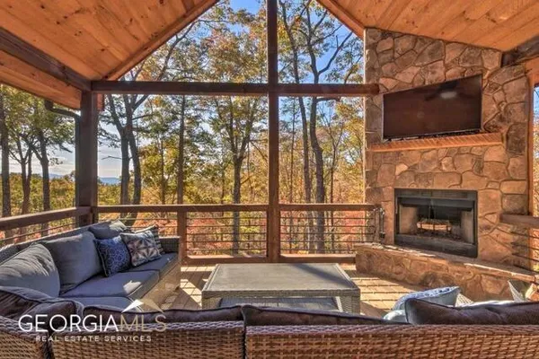 a living room with a fireplace and a flat screen tv