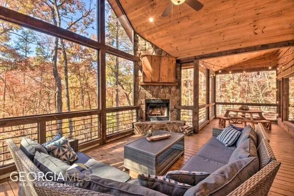 a living room with furniture and floor to ceiling windows