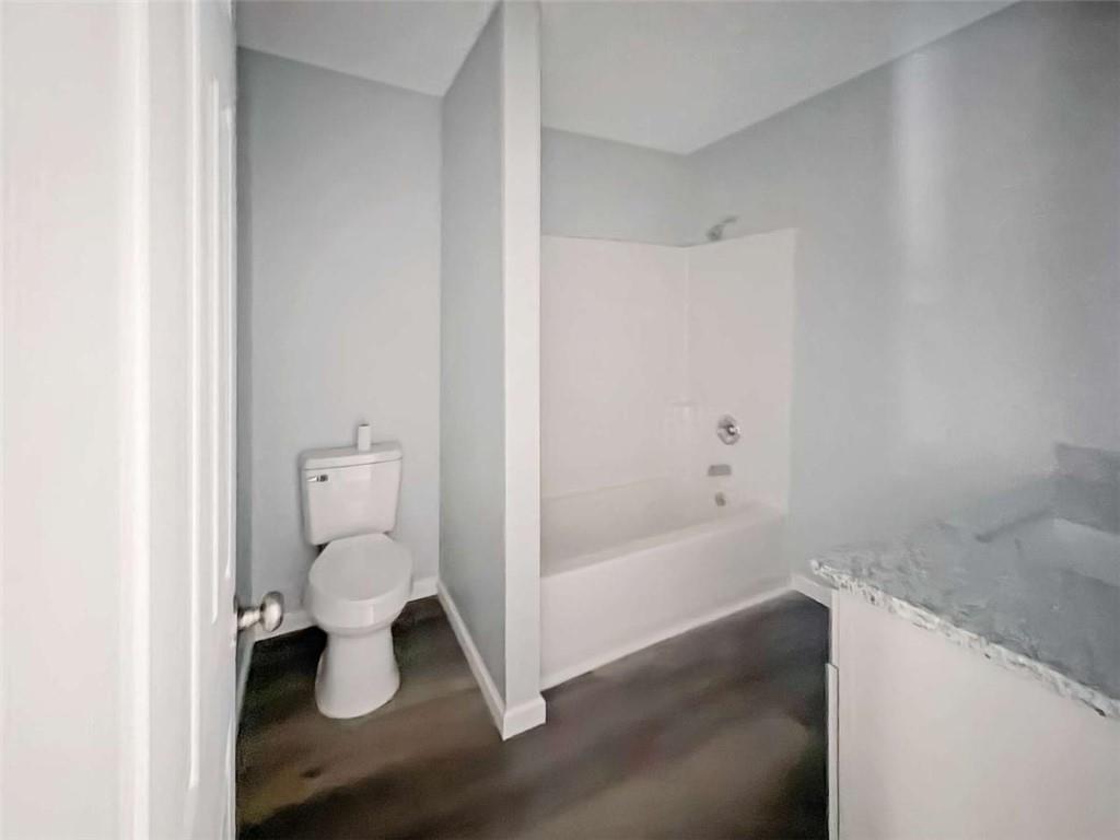 24 George Street Forsyth, GA 31029 - Photo 7 of 17 a bathroom with a toilet and a bathtub