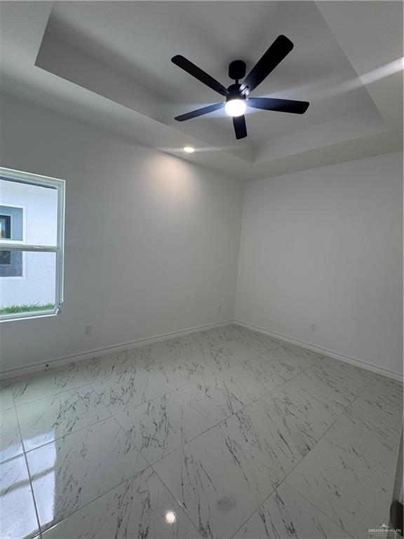 11403 North 24th Lane, Unit 1 McAllen, TX 78504 - Photo 11 of 13 an empty room with a ceiling fan and window